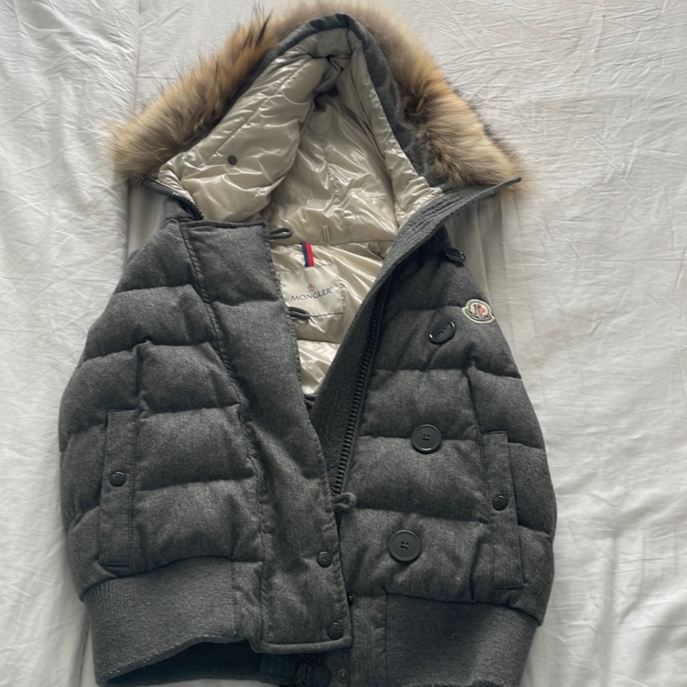 Gray Moncler puffer vest with fur hood.